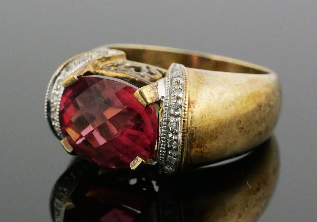 14K Gold Diamond Tourmaline Ring: 14 karat yellow gold set with diamonds and tourmaline. Central oval pink tourmaline accented with diamonds and heart filigree. 14 k yg, 10.8 grams tw. Size 6-1/4 - 6-1/2. This item can be shipped
