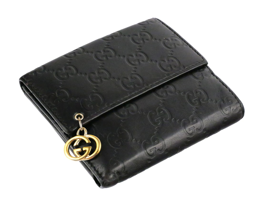 Gucci Guccissima Leather Wallet COA: Gucci GG monogram dark brown embossed leather wallet with gold tone GG charm. Serial number 212105-4276. One side with hidden snap closure and open pocket, the other with snap closure on tab with