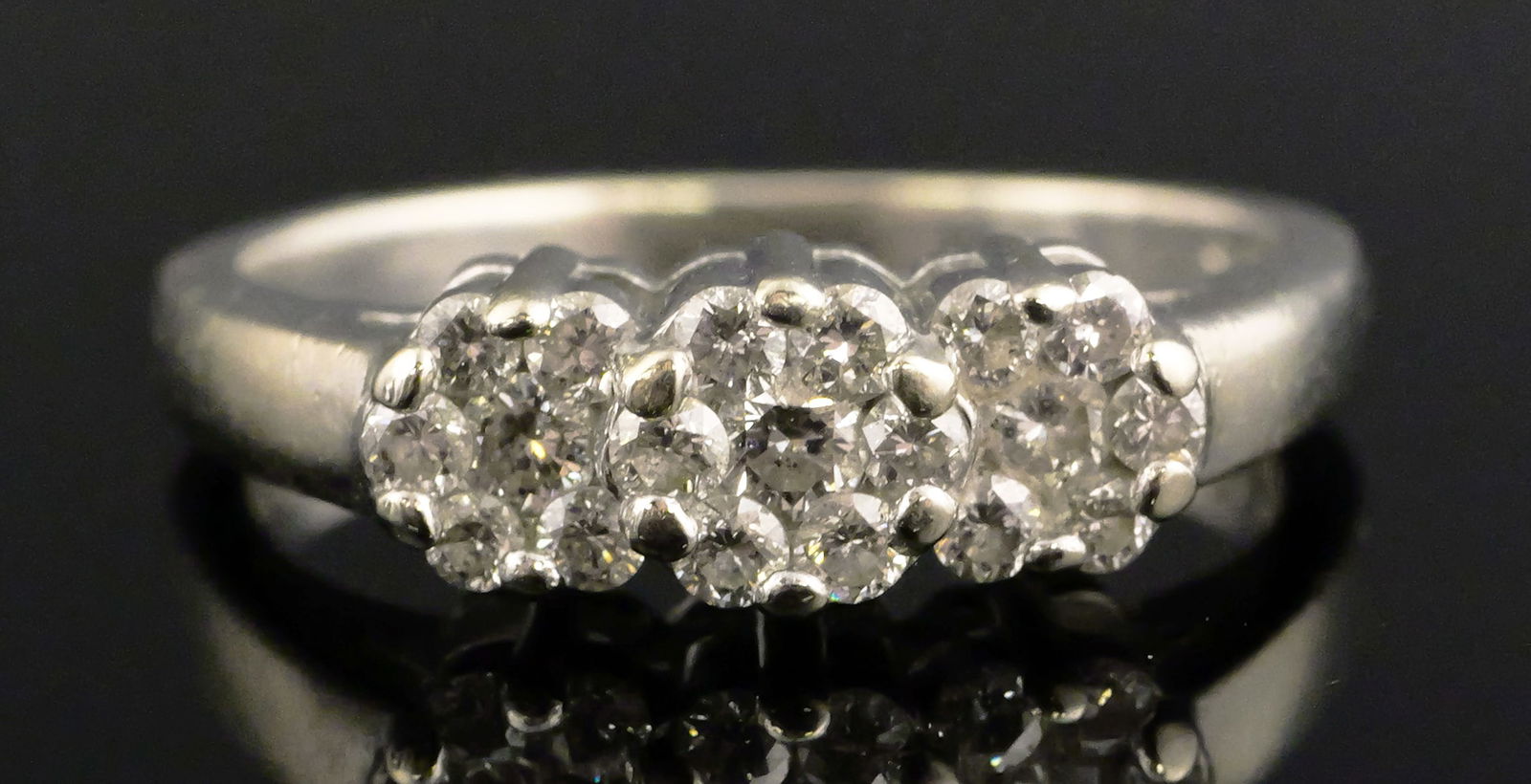 14K Gold Diamond Flower Ring: 14 karat white gold ring with diamonds. Triple, cluster, 3 flower design. 14 k wg, 4.3 grams tw. Size 6-1/2. This item can be shipped in-house. Multiple lot combined shipping may require 3rd Party