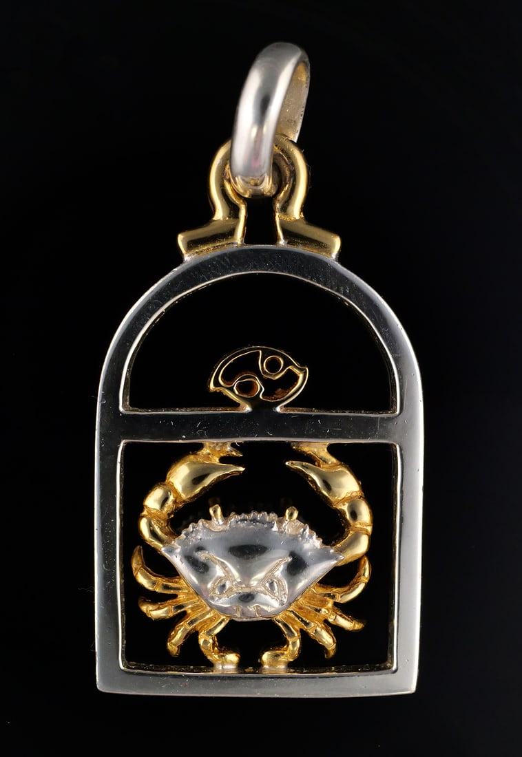 Sergio Bustamante Sterling/Gold Zodiac Pendant: Sterling silver astrological pendant, Cancer sign, with gold wash accents. Signed, Sergio Bustamante. 925, marked, 15.4 grams tw. 1"W, 2"L. This item can be shipped in-house. Multiple lot combined