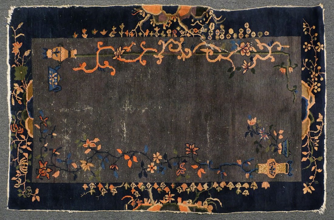 Chinese Pictorial Rug 50" x 83": Hand-knotted Chinese wool rug. Rectangular format measuring approximately 49" x 80". Gray open field with scattered floral sprays, vine scrolls and stylized vessel motifs. Wide dark blue border with c