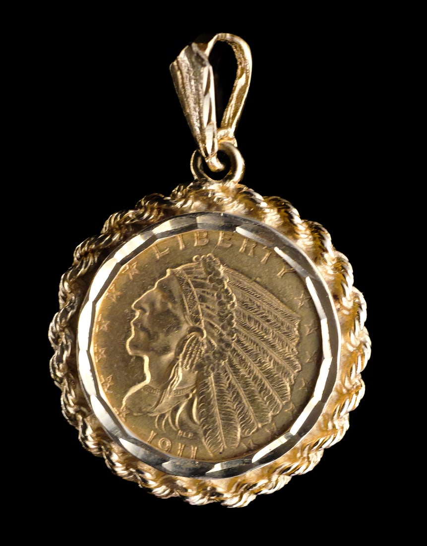 Gold 1911 Indian Head Quarter Eagle Pendant: U.S. 1911 Indian Head 2.5 dollar gold coin set in a 14k yellow gold pendant mounting. 2 1/2 dollar coin and 14k yg frame 7.8 grams tw. Approx. 7/8"wide x 1-1/4"L. This item can be shipped in-house.