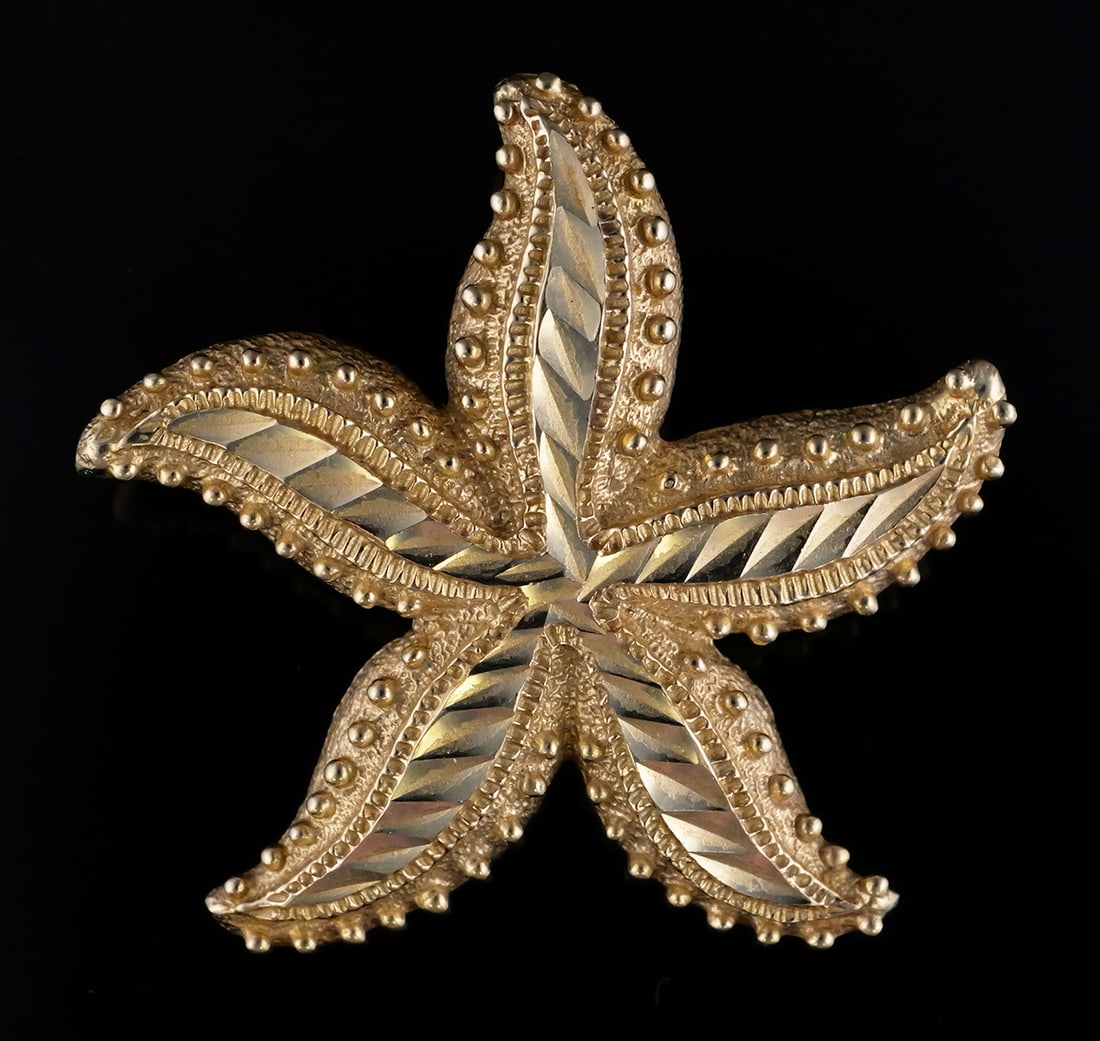 14K Gold Starfish Slide Pendant: 14 karat yellow gold starfish pendant or slide, diamond cut and granulation decoration. 14 k yg, 9.1 grams tw. Approx. 1-1/2"wide, 1-3/8"L. This item can be shipped in-house. Multiple lot combined