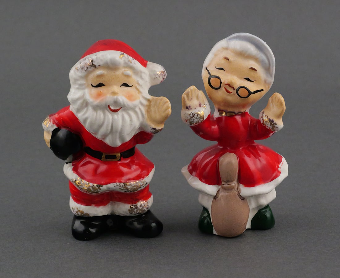 Enesco Bowling Santa & Mrs. Claus Shakers: Vintage mid century ceramic novelty salt and pepper shakers in the form of Santa with a bowling ball and Mrs. Claus with a bowling pin. Both with Enesco foil labels. 3-1/2"H. This item can be shipped