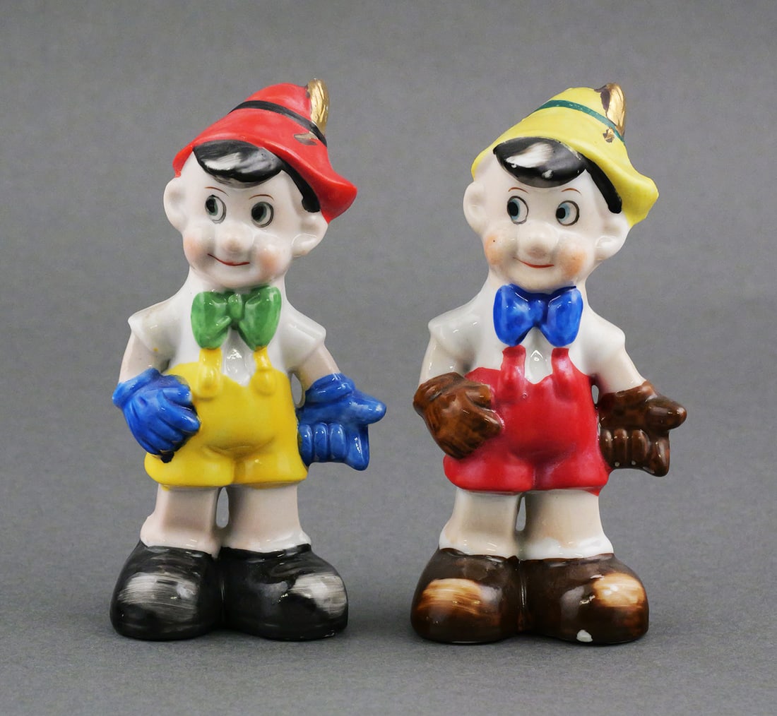 Vintage Pinocchio Salt & Pepper Shakers: Pair of vintage porcelain character novelty shakers based on the Disney Pinocchio character. Marked "Hand Painted Japan". Approx. 4-5/8"H. This item can be shipped in-house. Multiple lot combined