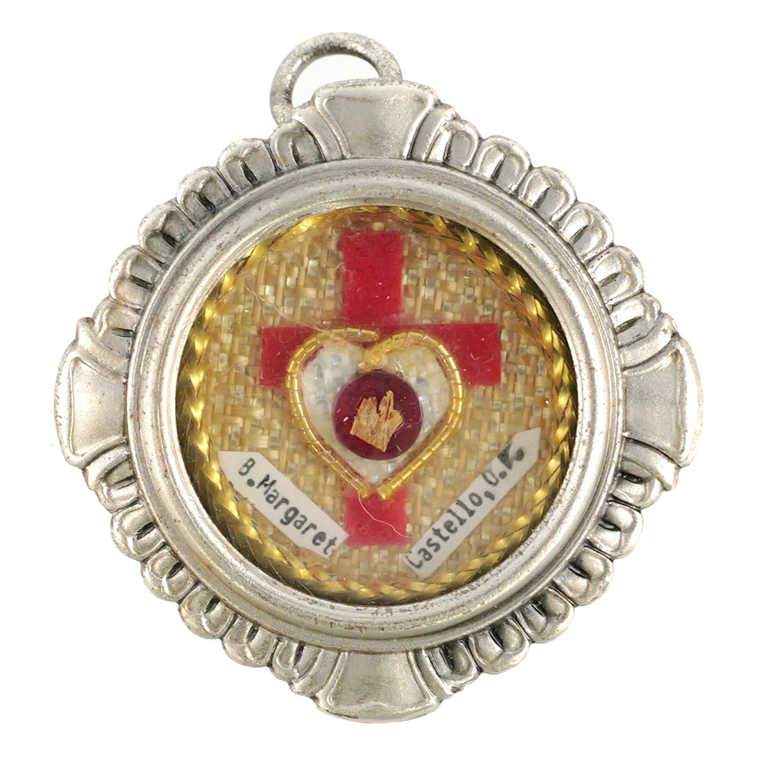 Saint Margaret of Castello Relic: St Margaret reliquary with skin fragment, with original COA. Metal reliquary theca with bail for hanging. Approx. 1-1/4"Dia. This item can be shipped in-house. Multiple lot combined shipping may requi