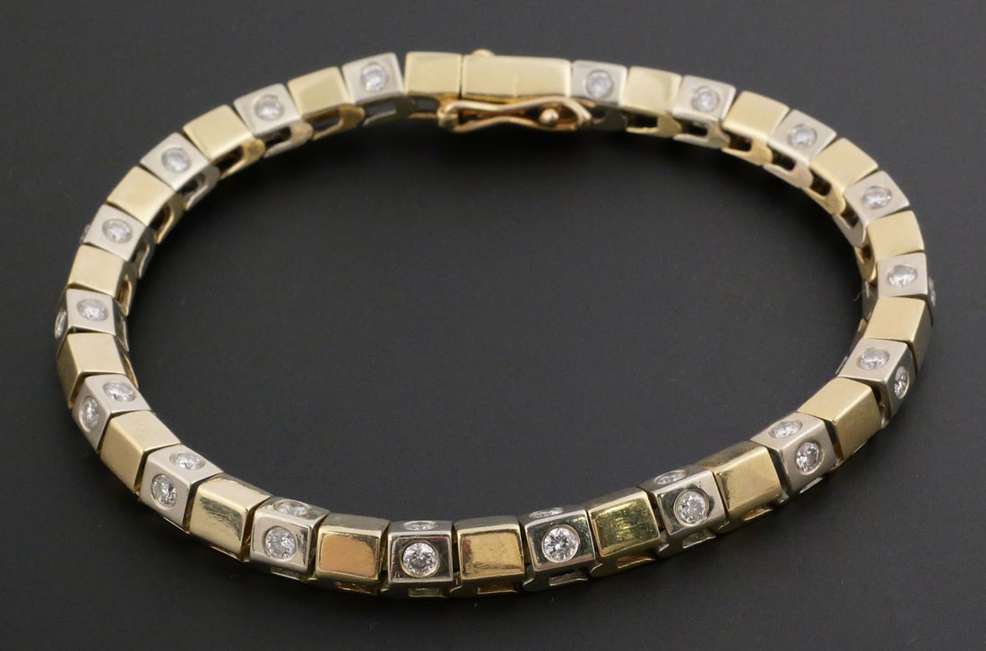 14k Gold & Diamonds Tennis Bracelet: Contemporary bracelet, white and yellow gold peaked links with diamonds mounted on each side of the white gold links, 36 total, each about 5 points. Diamonds about 1.38 cttw. Measures about 7-1/2" lon