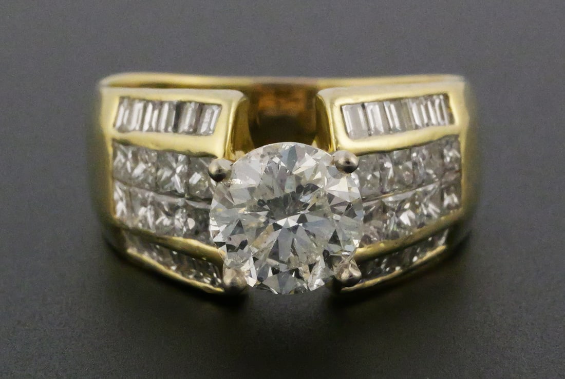18k Gold Princess Cut Diamond Ring 1.4 CT: Yellow Gold (18k) Round Brilliant Baguette Princess Cut Diamond Ring. Diamond is Round Brilliant Cut, diamond color H, 1.4 carats, SI2 clarity, symmetry Excellent, Polish Excellent. Diamond setting