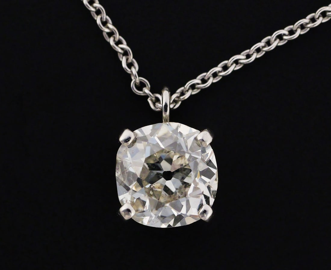 1.55 Carat Diamond Solitaire Necklace: Stunning antique cushion cut diamond, 1.55 carat, color J-K, clarity SI. 14k white gold necklace and setting. 2.9 grams total. This item can be shipped in-house. Multiple lot combined shipping may