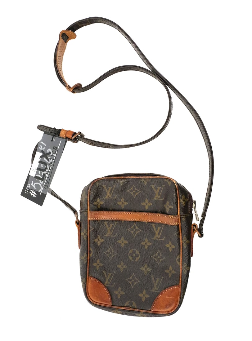 Louis Vuitton Monogram Danube Crossbody Bag: Louis Vuitton Monogram Danube Crossbody Bag. Measures approx 6-1/2" wide x 8-3/4" tall x 1-1/2" deep. Strap is adjustable up to 22" from top of bag. Unconditionally guaranteed to be authentic. This