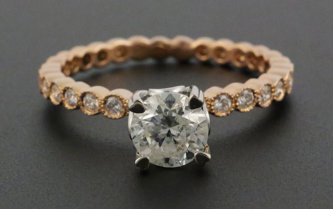 18k Round Brilliant Cut Diamond Ring: 18k Round Brilliant Cut Diamond Ring. Center Diamond: Round Brilliant Cut, Weight 1.3 carats, Color H, Clarity S12. Adjacent diamonds (14) are Round Brilliant cut, Total weight .21 carats, Color grade