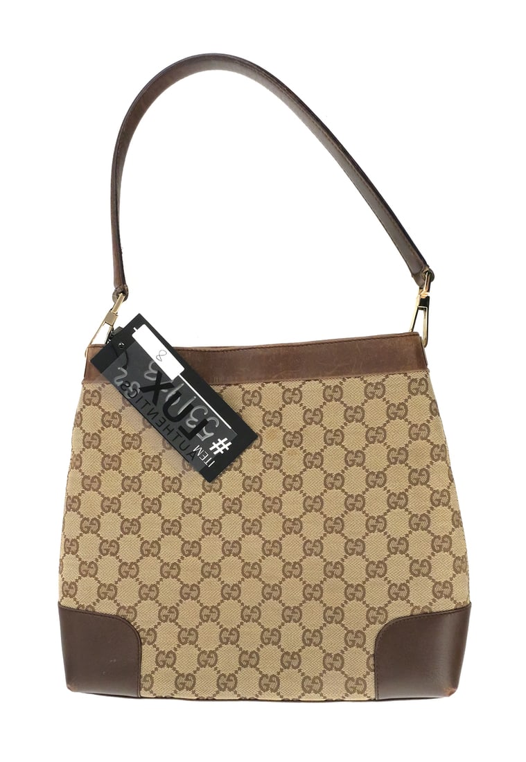 GUCCI Canvas GG Shoulder Bag: GUCCI GG Canvas Shoulder Bag, No. 33900. Measures 11" wide at the bottom, 10" tall, 2" deep. Strap rises 9" from top of bag. Unconditionally guaranteed to be authentic. This item can be shipped