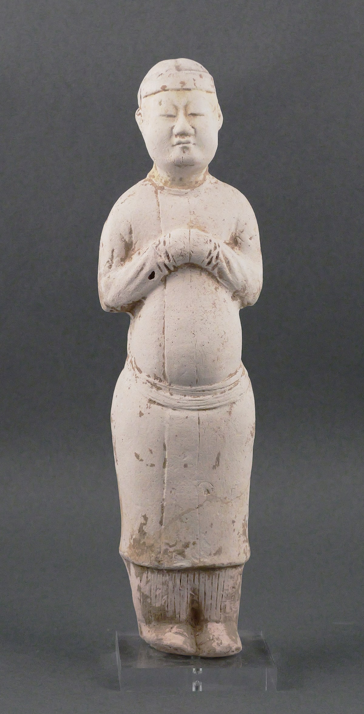Tang Dynasty Chinese Terracotta Man Figure: Ancient Chinese terra cotta statue of a man with hands folded across his chest. Circa 7th to 10th century. Measures about 11-7/8" high not including lucite stand. Unconditionally guaranteed to be auth