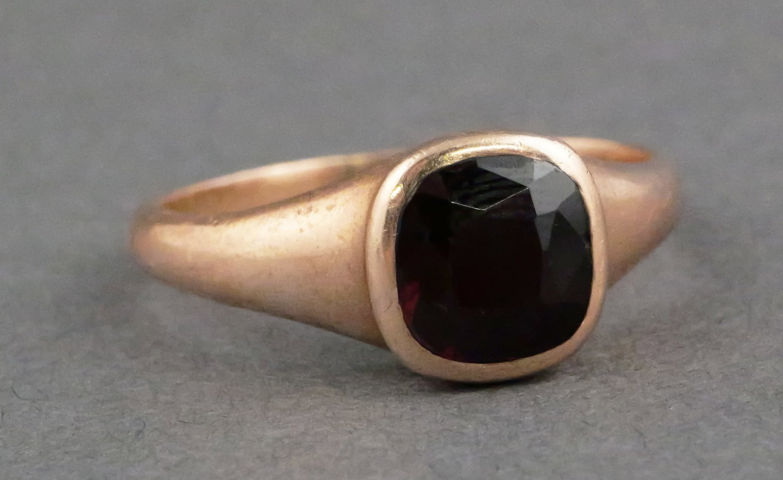 10K Rose Gold Garnet Ring: Antique 10 karat rose gold ring set with a faceted garnet in a closed setting. Tests as 10 k, 4.1 grams tw, size 9. This item can be shipped in-house. Multiple lot combined shipping may require 3rd