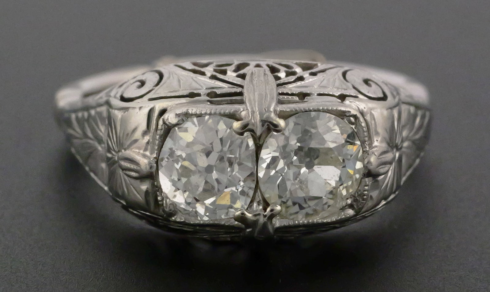 14K White Gold & Platinum Diamond Ring: 14K White Gold & Platinum Diamond Ring. Antique engraved mount with mounted dual diamond. Natural diamonds, Mine cut and Old European cut. Approx 1.25 diamond carat weight. Weight 4 grams. This item c
