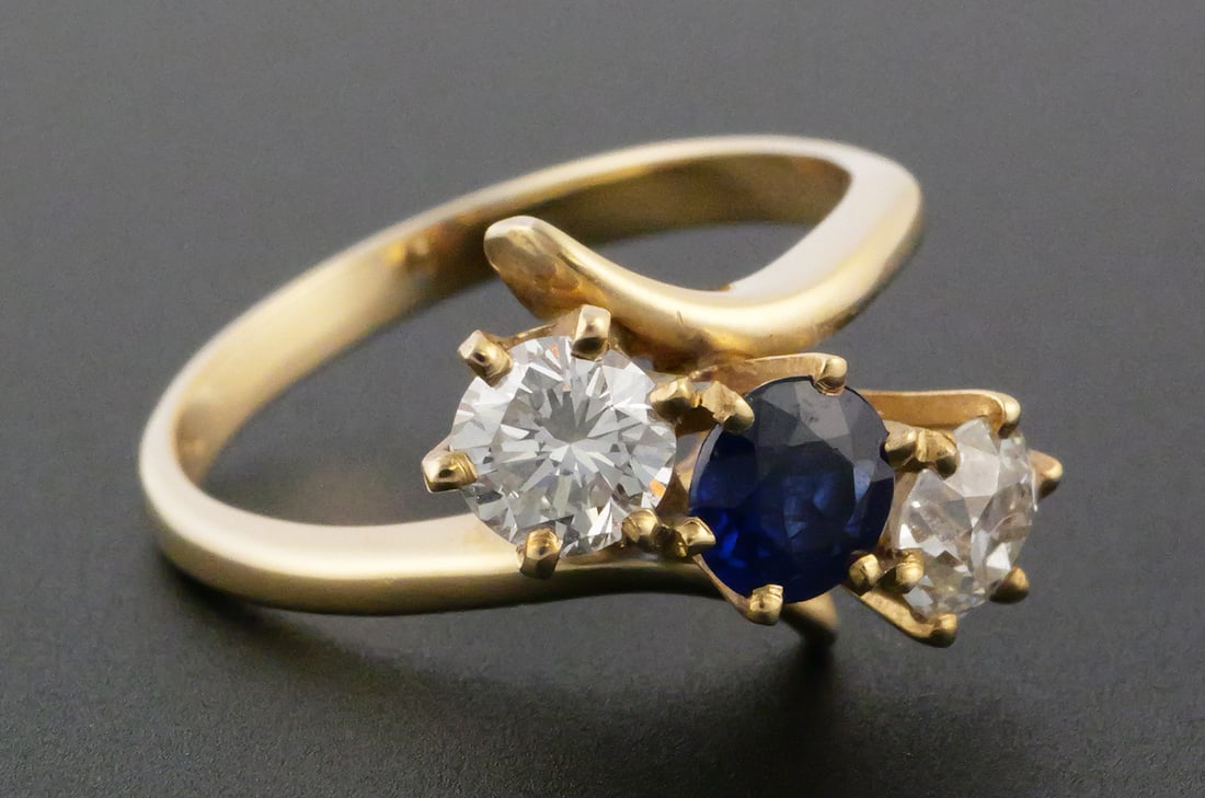 14k Gold Diamonds & Sapphire Ring: Diamonds about .40 ct each, flanking a sapphire. Size 7, 4.0 grams. This item can be shipped in-house. Multiple lot combined shipping may require 3rd Party shipping.