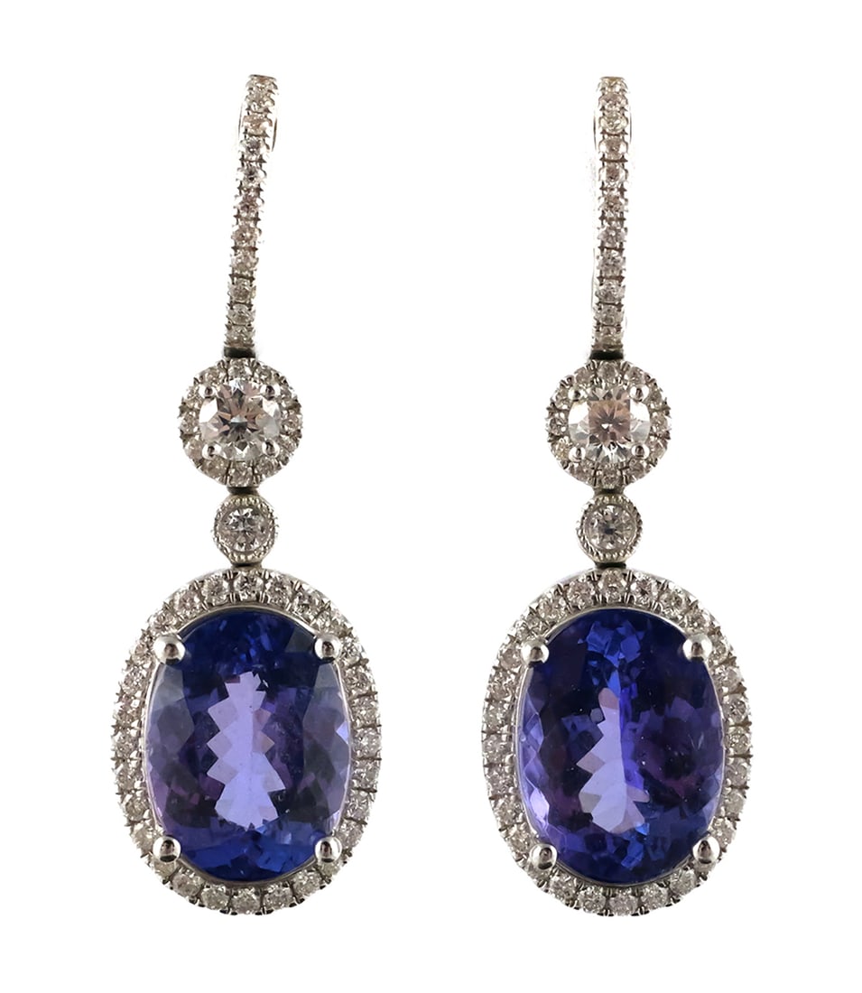 18k Gold Tanzanite & Diamond Earrings: 18k white gold tanzanite and diamond earrings. Oval tanzanites are about 3.7 carats each, VVS clarity. Set has 106 prong and bezel set diamonds, total diamond weight about 1.4 carats. Weight is 8.5