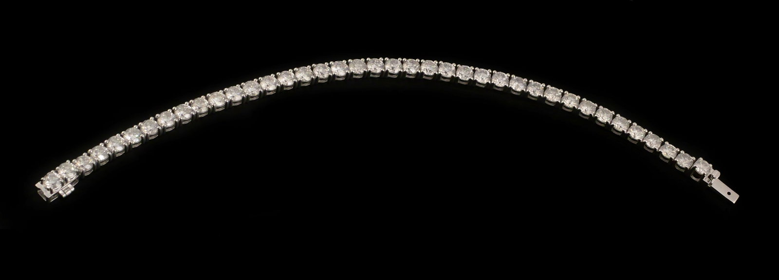 Platinum 13.91 CTW Diamond Tennis Bracelet: Platinum (.900) diamond tennis bracelet set with 39 round brilliant-cut natural diamonds totaling approximately 13.91 carats. The bracelet measures 7-3/8" long and has a gross weight of 24.3 grams.