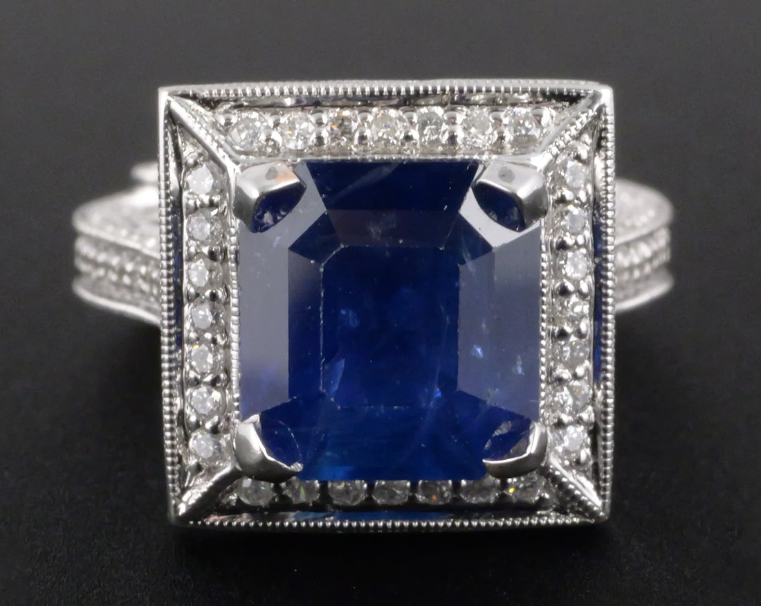 18K Gold Sapphire & Diamond Ring: 18K white gold ring set with one octagonal step-cut natural blue sapphire weighing approximately 4.35 carats and 168 round brilliant-cut natural diamonds totaling approximately 1.35 carats. Diamonds
