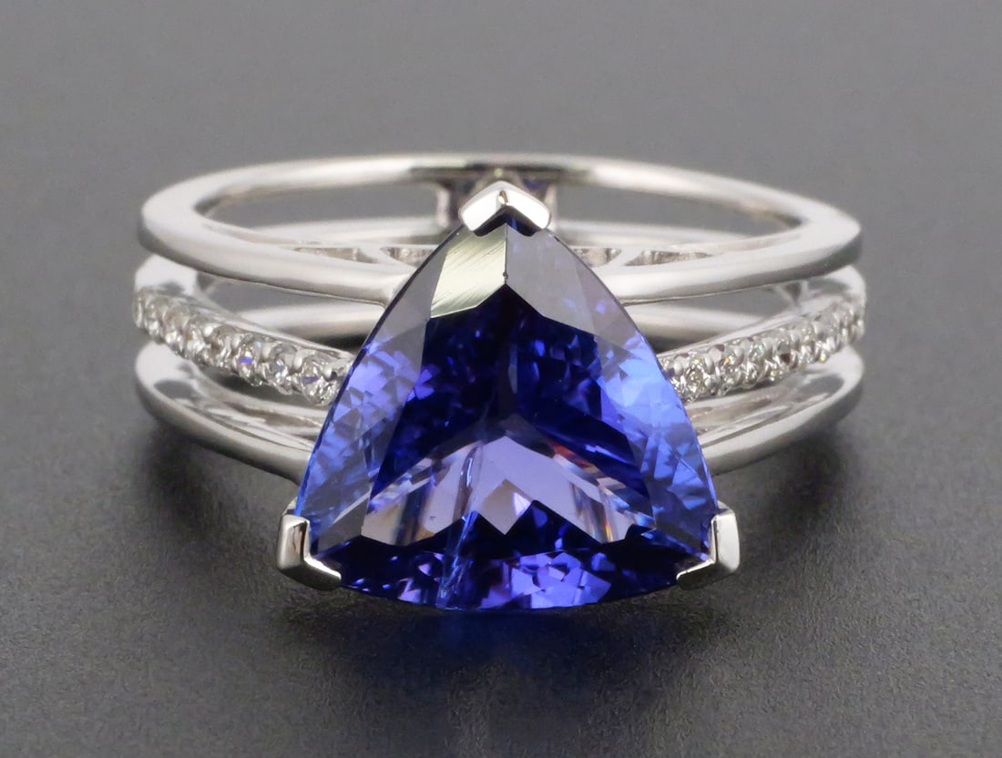 14K Gold Tanzanite & Diamond Ring: 14K white gold ring set with one triangular brilliant-cut natural tanzanite weighing approximately 3.61 carats and 16 round brilliant-cut natural diamonds totaling approximately 0.17 carats. Diamonds