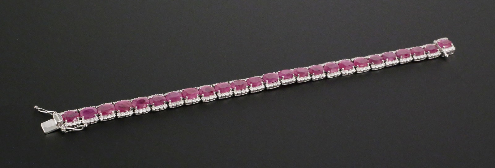 Platinum Burmese Ruby & Diamond Bracelet: Showstopping platinum bracelet with 21.3 carats of 25 natural Burmese rubies and 3.02 carats of diamonds. Rubies are framed by 200 round, brilliant cut diamonds (F-G color, VS2-SI2). Total weight is