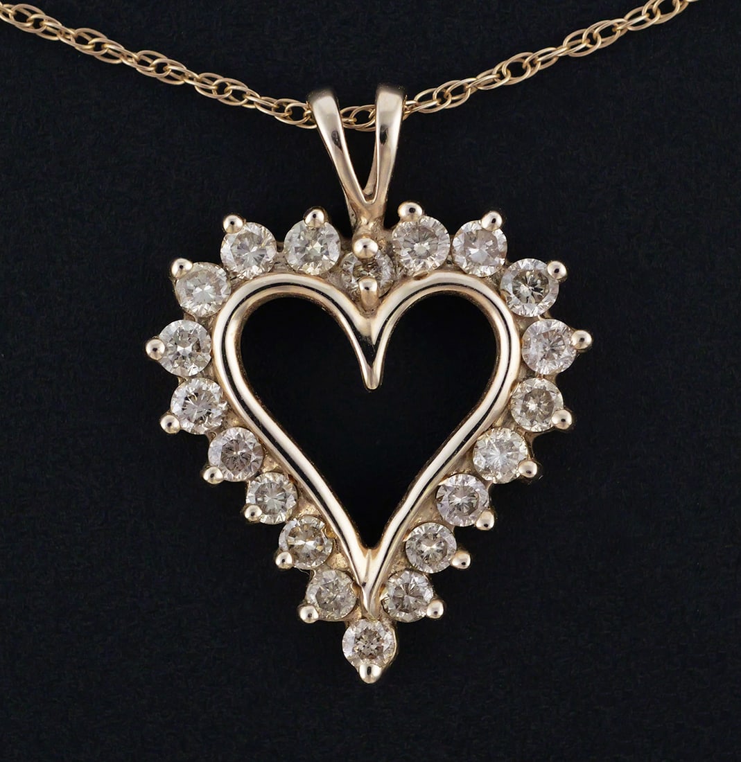 10K Diamond Heart Pendant & Necklace: 10 karat yellow gold heart pendant set with 20 diamonds, on a delicate rope link necklace. 10 k gold, 3.5 grams tw, pendant approx. 1" L, necklace 18" L. This item can be shipped in-house. Multiple