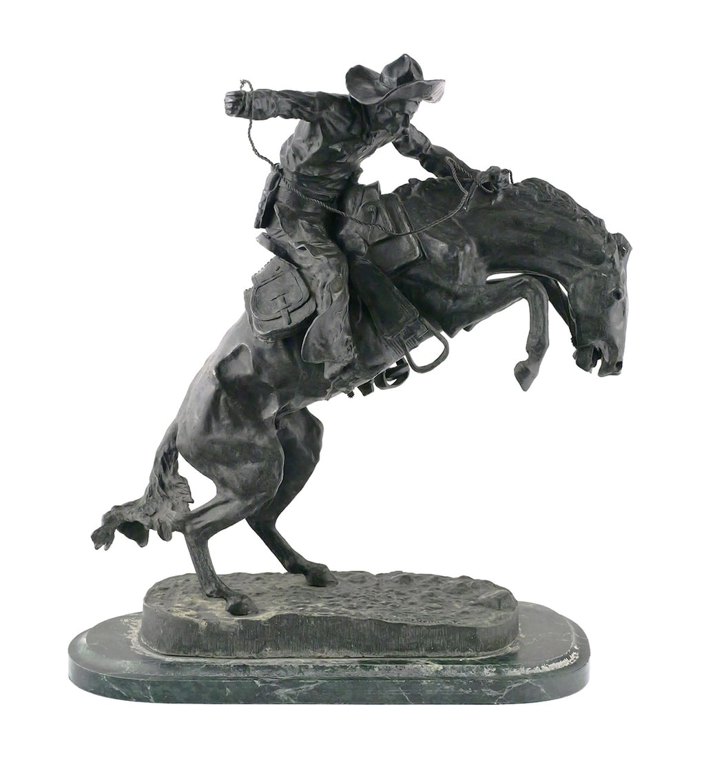 Frederic Remington Broncho Buster Bronze: After Frederic Remington (American, 1861-1909), "The Bronco Buster," patinated bronze sculpture depicting a cowboy astride a rearing horse, with whip raised in his right hand. Commonly known as the