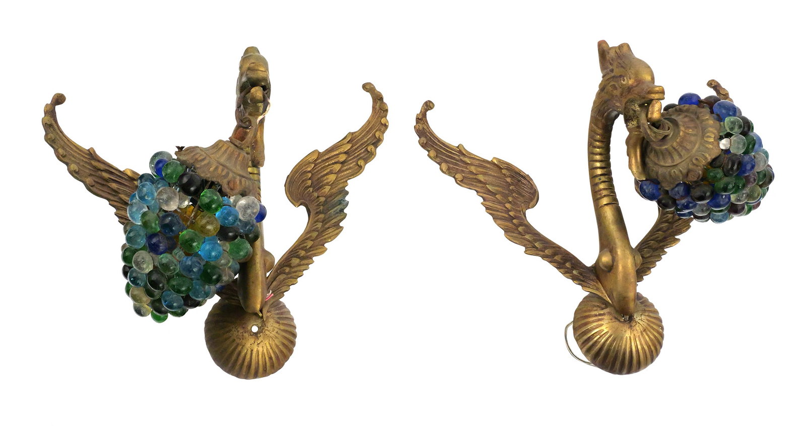 Pair Italian-Style Gilt Brass Glass Grape Sconces: Pair of mid-century Italian-style gilt brass or bronze wall sconces, each modeled with an elaborate winged mythological creature supporting a pendant cluster of multicolored glass grapes. The
