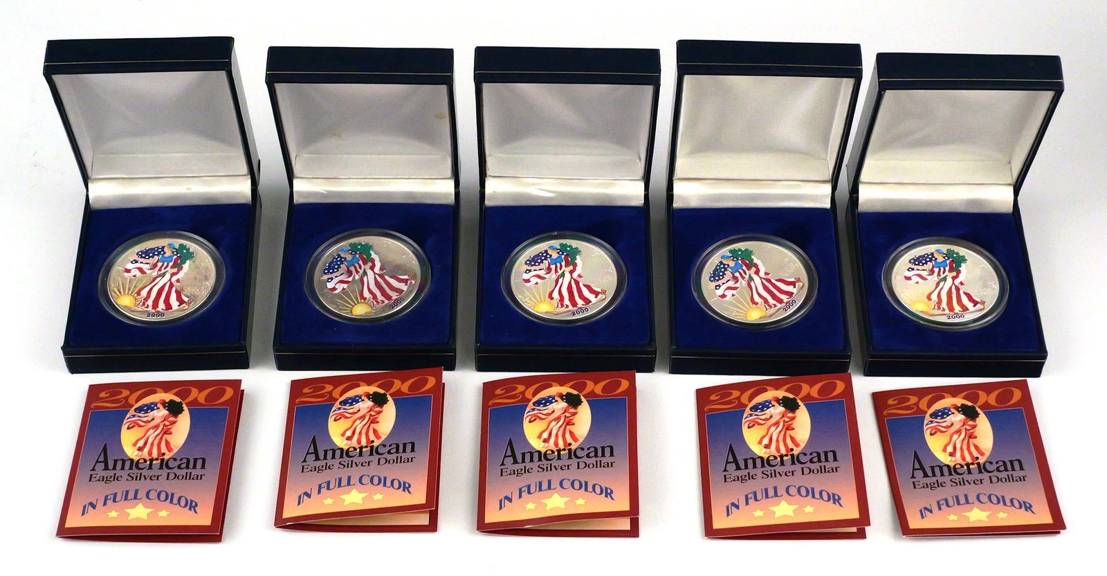 (5) 2000 American Eagle Silver Dollars in Color: (5) 2000 American Eagle Silver Dollars in Full Color. The coins are made of 0.999 silver and weigh 1 oz. Come with original boxes and paperwork. This item can be shipped in-house. Multiple lot