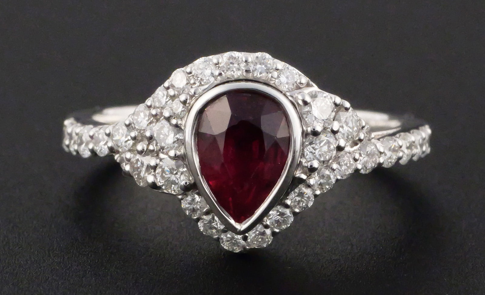 Karl Haas Platinum GIA Ruby Diamond Ring: Karl Haas platinum ring set with a GIA-certified 1.00 ct. pear-cut natural ruby and 31 round brilliant-cut natural diamonds totaling approximately 0.54 ct., F-G color, VS2-SI1 clarity. Gross weight