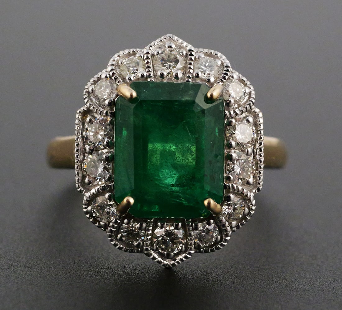 14K Two-Tone Gold Emerald Diamond Ring: 14K yellow and white gold ring set with a 3.43 ct. octagonal step-cut natural emerald and 14 round brilliant-cut natural diamonds totaling 0.58 ct., G-H color, VS1-SI1 clarity. Gross weight 4.0