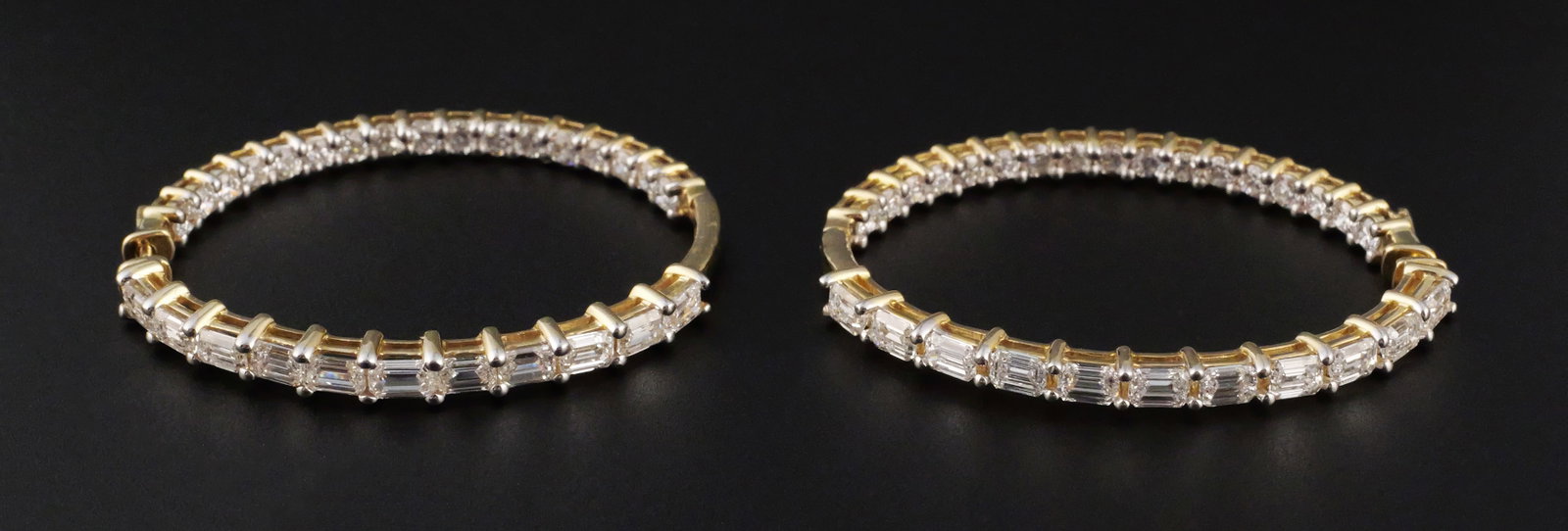 14K Gold Diamond Hoop Earrings: Pair of 14K yellow gold hoop in and out design earrings set with baguette-cut and round brilliant-cut diamonds. Each hoop measures approximately 1-1/2" x 1-1/4". Gross weight 8.4 grams. Marked "14K