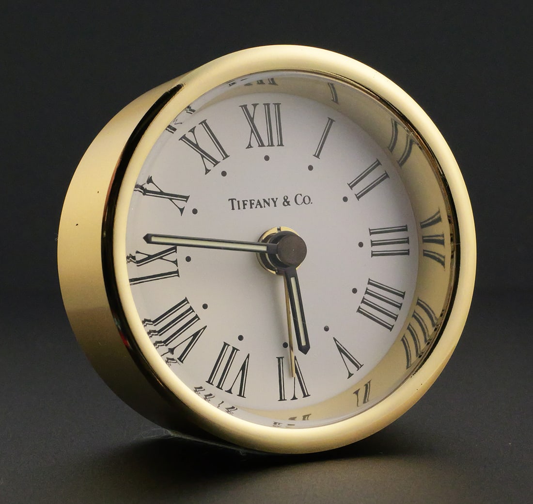 Tiffany & Co Travel Clock: Tiffany & Co Travel Clock with original sleeve, box and paperwork. Measures approx 2-1/4" diameter. This item can be shipped in-house. Multiple lot combined shipping may require 3rd Party shipping.