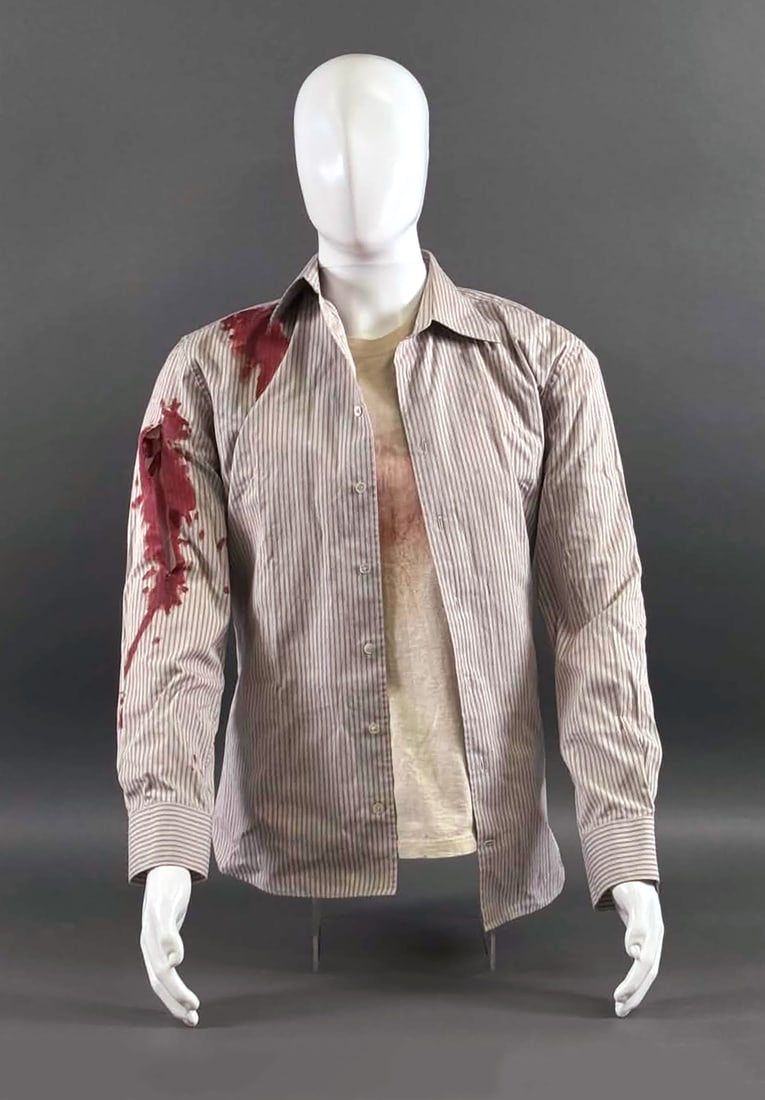 Cloverfield Movie Michael Stahl-David Costume: Screen-used hero costume worn by Michael Stahl-David as Rob Hawkins in the 2008 film Cloverfield. Costume includes a John Varvatos U.S.A. striped button-front shirt with production-applied simulated