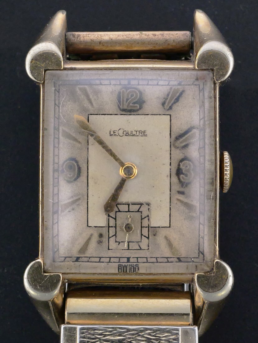 LeCoultre Art Deco Wristwatch: Vintage LeCoultre manual-wind wristwatch with a 17-jewel movement and gold-filled case. Rectangular Art Deco-style case with large ornamental lugs, silver-tone dial, applied Arabic numerals at 12, 3