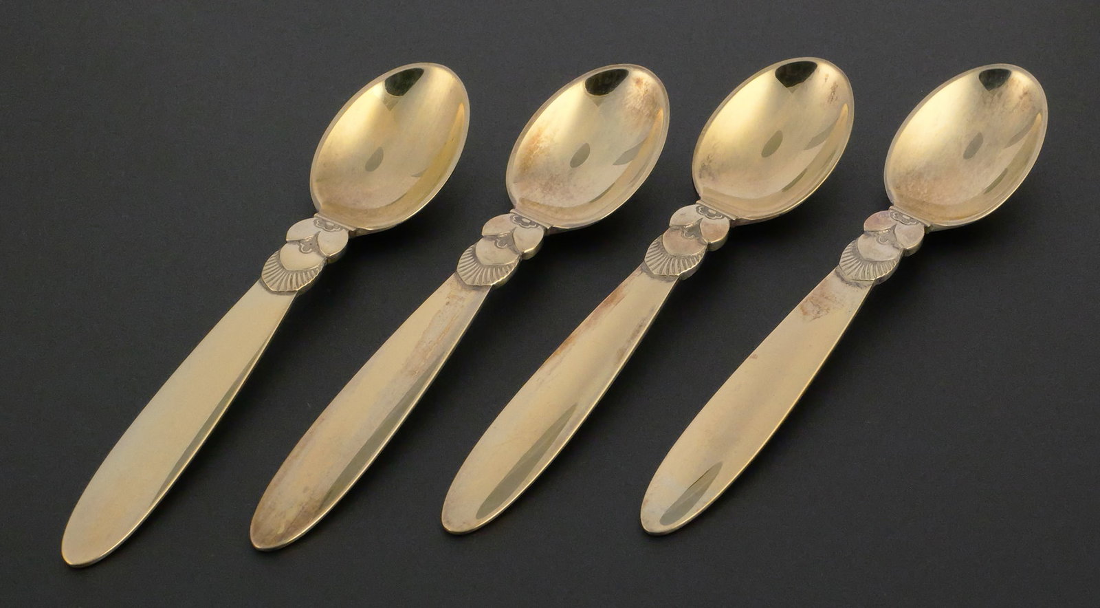 GEORG JENSEN Cactus Spoons Set Of Four: Set of four Georg Jensen "Cactus" pattern demitasse spoons. Sterling with a gold wash, 60.3 grams tw, 4"L. This item can be shipped in-house. Multiple lot combined shipping may require 3rd Party