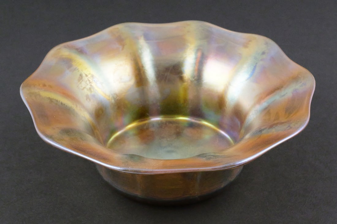 Signed Tiffany Favrile Iridescent Art Glass Bowl: Signed L.C. Tiffany Favrile Iridescent Art Glass Scalloped Bowl, ca. 1900. Measures approx 2" tall, 6-3/8" wide. This item can be shipped in-house. Multiple lot combined shipping may require 3rd