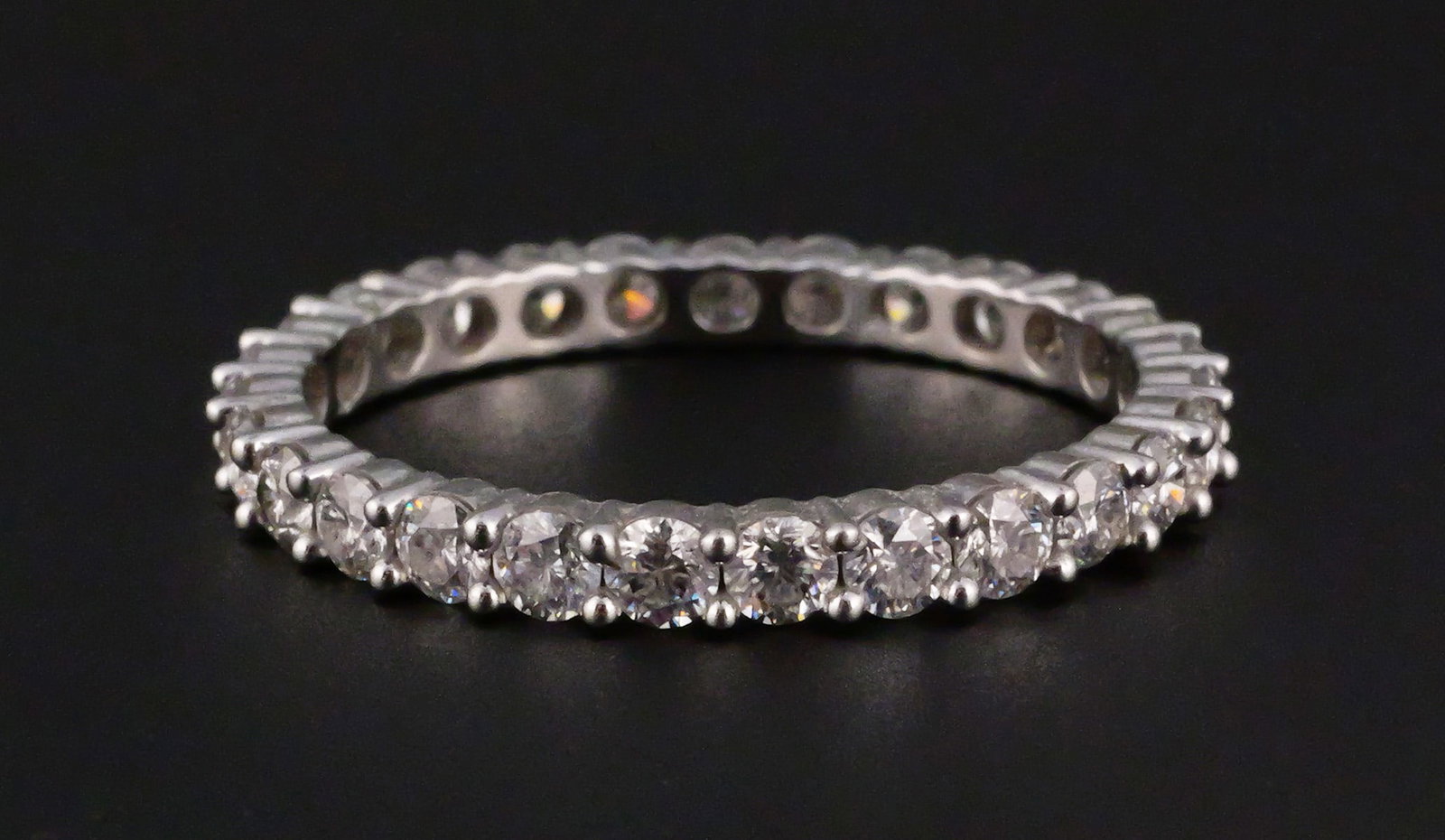 14K White Gold 1.44 CTW Moissanite Eternity Ring: 14K white gold eternity band set with round Moissanite Fire gemstones totaling 1.44 CTW. JTV authenticity and warranty card included. Ring size 9-1/2. Overall weight 2.3 grams. This item can be