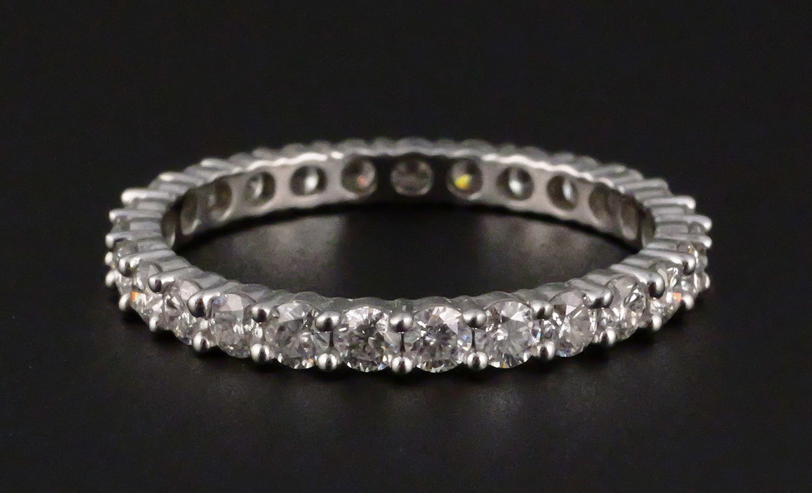 14K White Gold 1.44 CTW Moissanite Eternity Ring: 14K white gold eternity band set with round Moissanite Fire gemstones totaling 1.44 CTW. JTV authenticity and warranty card included. Ring size 9-1/2. Overall weight 2.3 grams. This item can be