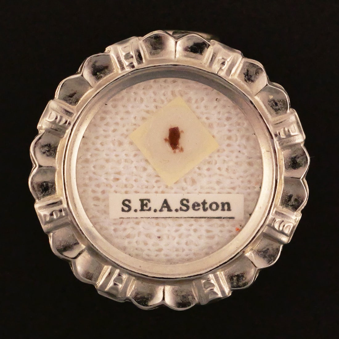 Reliquary Theca St. Elizabeth Ann Seton: Reliquary theca, presumed to be first class with wax seal. S.E.A. Seaton is known as the patron saint of Catholic schools and widows. Housed in a theca of silver metal. Approx. 7/8". This item can be