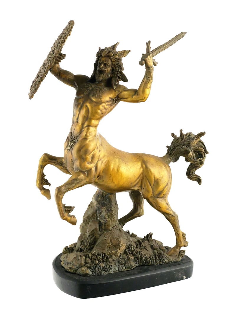 Bronze Centaur Warrior Sculpture: Patinated bronze figural sculpture depicting a muscular centaur warrior with horned head, raised sword and shield. The centaur is modeled in a rearing pose on a naturalistic rocky ground and mounted