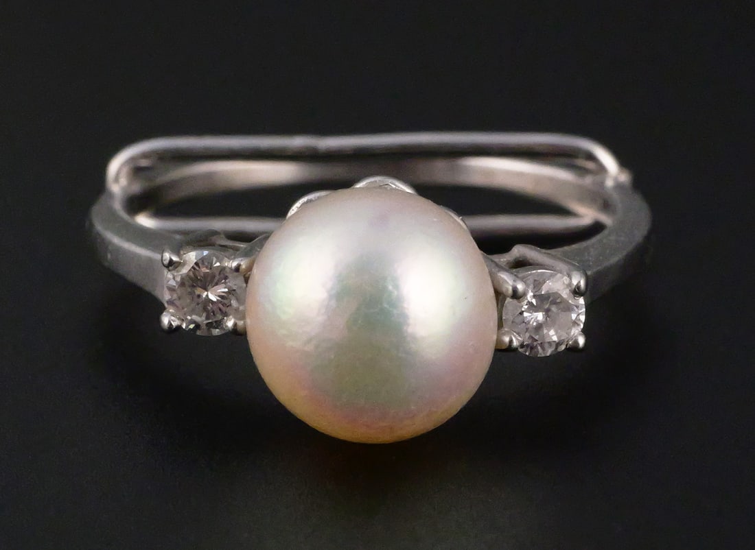 14K Gold Diamond and Pearl Ring: 14K Gold Diamond and Pearl Ring. Size is about a 7-1/2. Weight is approx 3.4 grams (with stones and pearl). Marked with a "14K" and a "C". No other markings. The ring does come in a Tiffany bag, but t