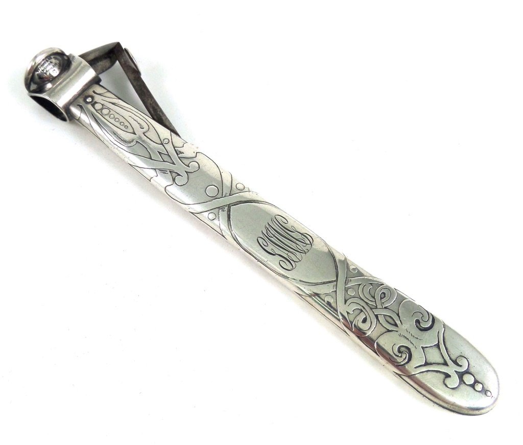 Tiffany Co. Makers sterling vintage cigar cutter: 5 1/2 inches long sterling cigar cutter by Tiffany. One side is monogrammed. Rare and unique. Art nouveau design on handle. Estimate $250-$500