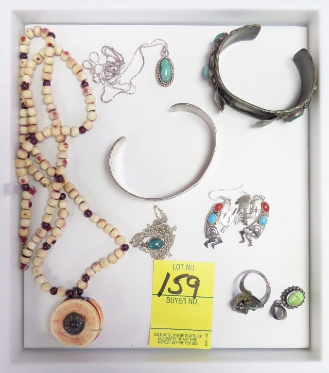 Lot of 8 sterling silver pieces of jewelry: Lot consists of 1 Indian silver watch bracelet. The one necklace appears to be bone with garnet beads. The pendant has silver trim. Nice cat ring with marcasite.