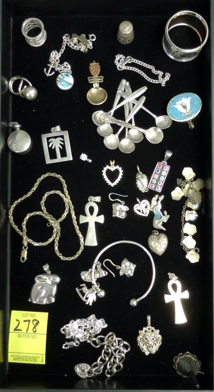 Sterling silver jewelry tray lot 33 pieces: 245.2 grams of sterling silver jewelry including salt spoons, enameled charms, perfume, napkin ring, thimble, bracelets and earrings . Nice collection. Auction estimate $125 - $225