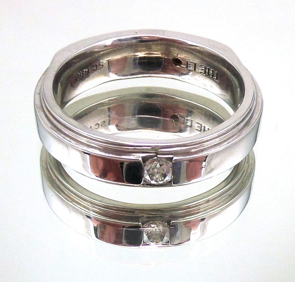 THE LEO Diamond 14k White Gold Band .20 ct Ring: Fine 14k wg diamond band with channel set .20 ct diamond. Signed THE LEO. Leo logo diamond is missing. Total weight 14.6 grams. Appraised $1,875 (appraisal included).