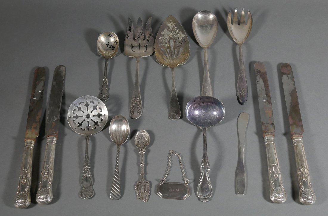 Tray of 15 Antique Silver Flatware Serving Pieces: Gin bottle label, miscellaneous pieces.