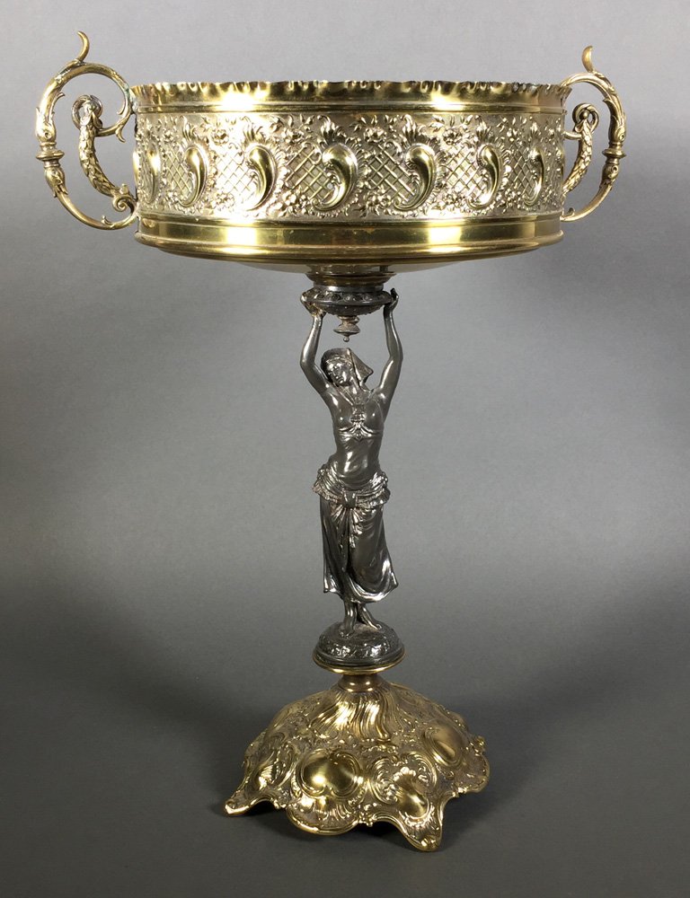 Old EGYPTIAN REVIVAL Figural Mixed Metal Tazza: Circa 1900 brass and silverplate tazza, measuring about 16" high. Ornate, handled repousse top held aloft by semi-nude woman wearing what appears to be an Egyptian headdress. Top is slightly askew fro