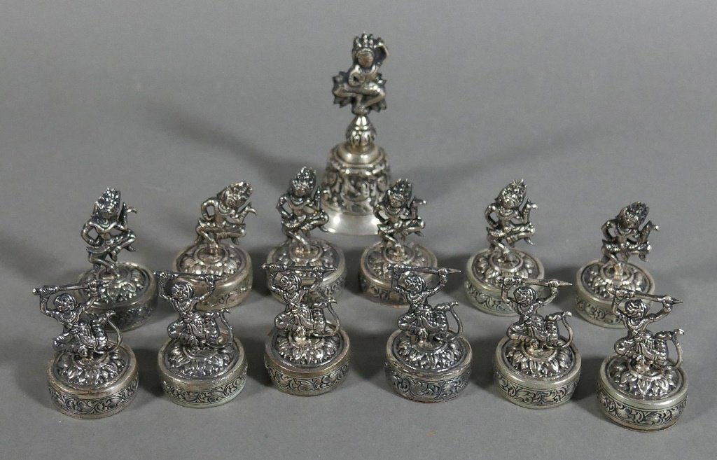 12 Khmer 900 Silver Place Card Holders & Bell: Set of 12 Cambodian .900 (coin) silver place card holders and bell. Marked "Cambodge 900" on bottoms. Holders are 1-3/4" high, and bell is 3" high. Good condition.