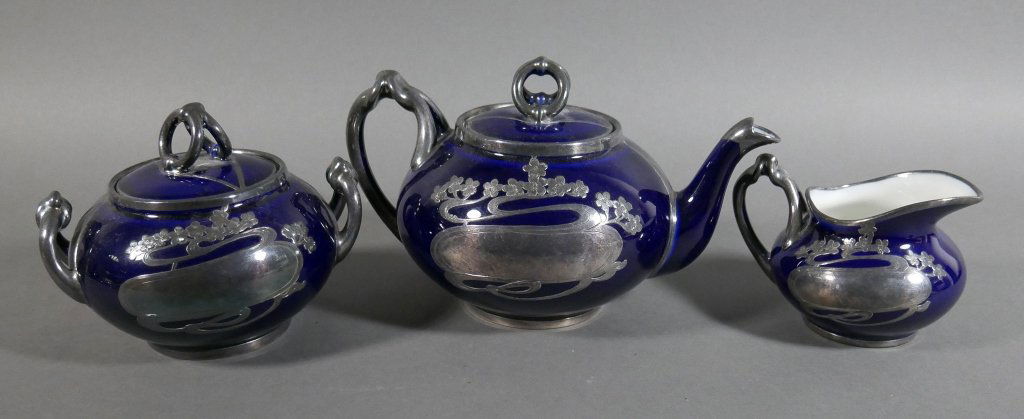 Art Nouveau LIMOGES Silver Overlay Tea Set Guerin: Circa 1900 silver overlay Limoges teapot, creamer and lidded sugar bowl with elegant Art Nouveau designs, made by Wm. Guerin. Set is in superb condition, with no damage and no visible wear. Teapot mea